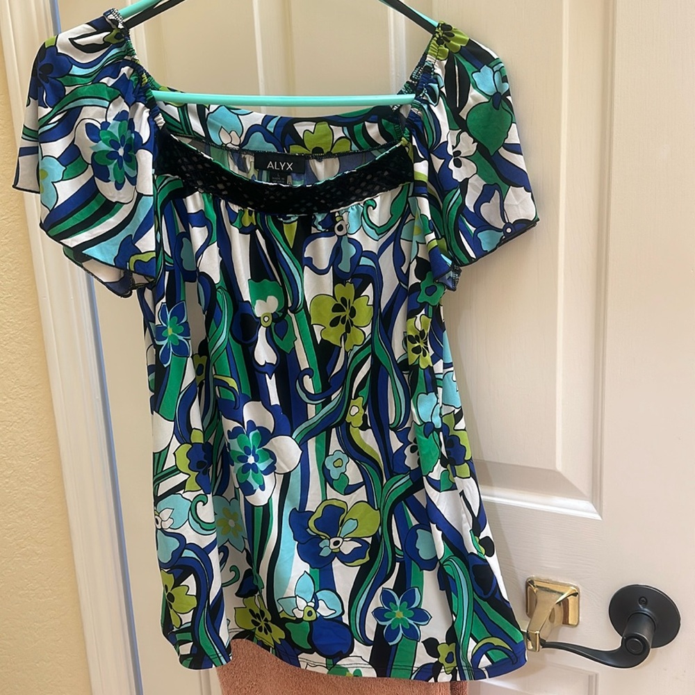 Colorful, teal blue, white, and green with flower designs below the waist